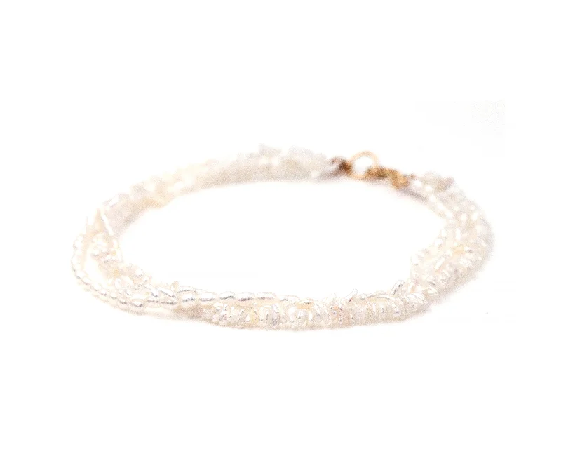 Vintage silver bangles with intricate engraved patterns -Three Strand Pearl Bracelet